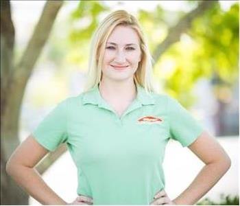 female employee in green shirt with blonde hair