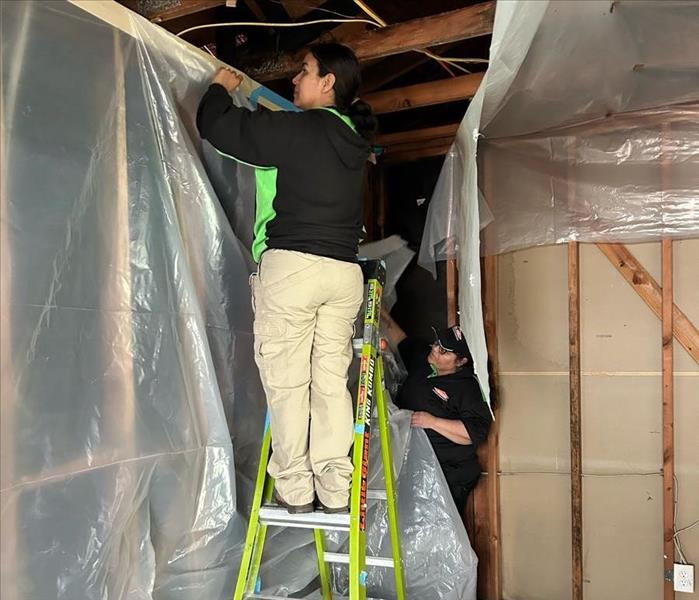 two technicians installing a containment