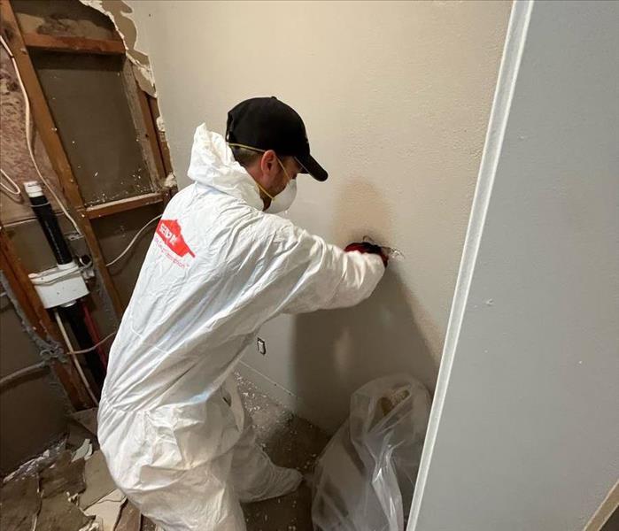 technician removing drywall