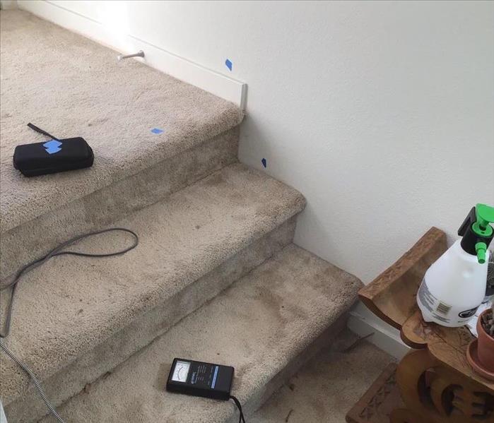 carpet stairs with blue tape on walls and carpet